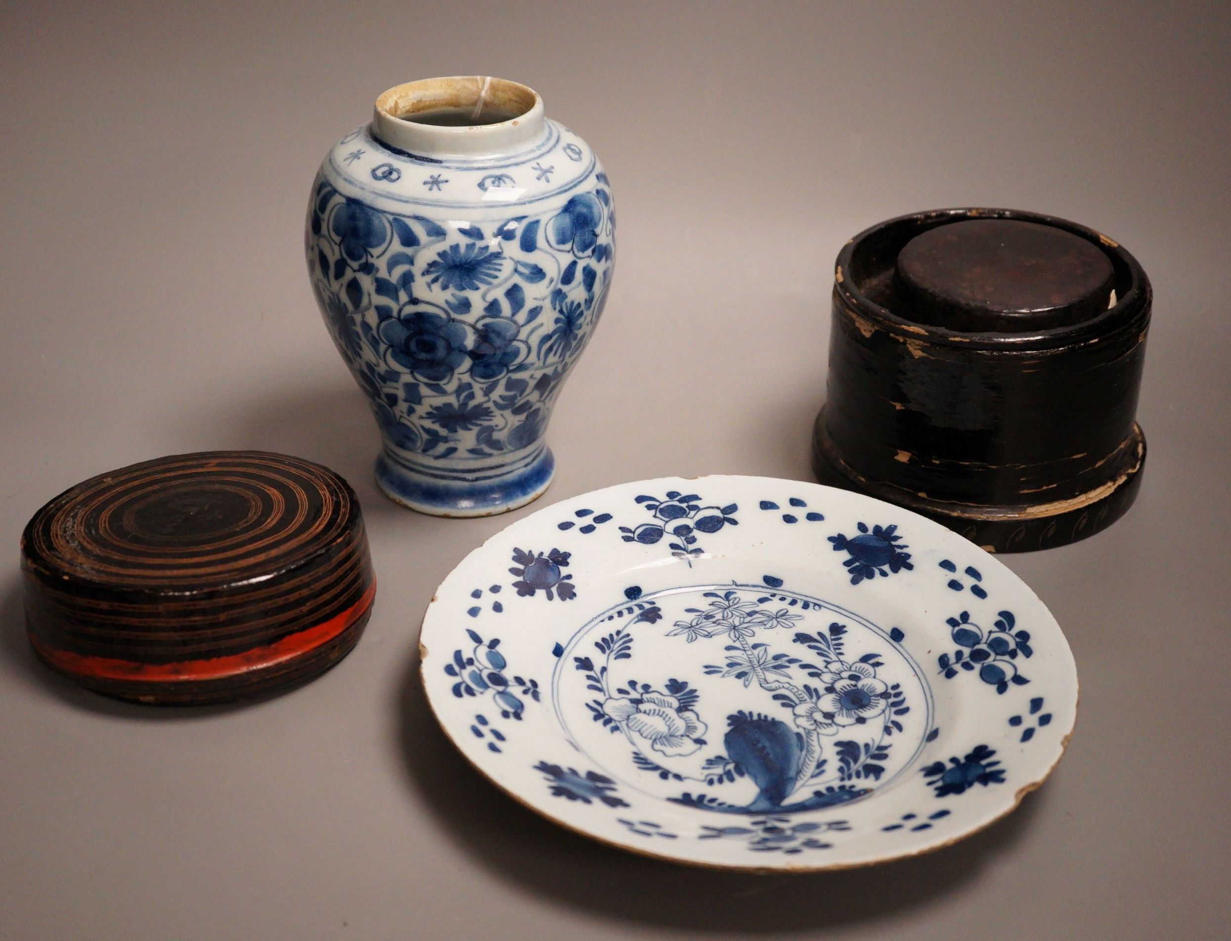 An 18th century Delft blue and white vase, a similar plate and two papier mache boxes, plate diameter 23cm